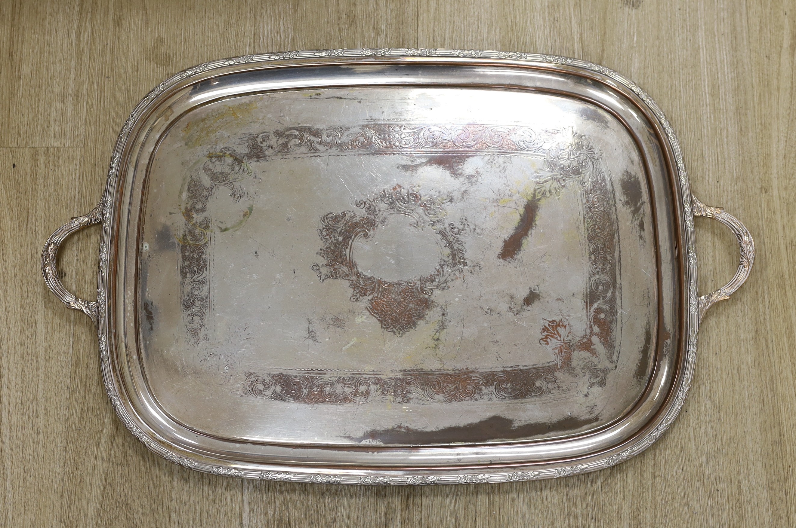 A small collection of plated wares, including an oval tray, an entree dish and cover, cutlery etc.